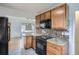 Contemporary kitchen featuring granite countertops, sleek appliances, and open access to adjacent living area at 3600 Olive St, Denver, CO 80207