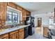 Well-lit kitchen featuring granite countertops, tiled backsplash, modern appliances, and ample cabinet space at 3600 Olive St, Denver, CO 80207