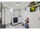 Basement laundry room with washer, dryer, sink, storage shelves, and small windows at 3600 Olive St, Denver, CO 80207