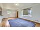 Bright living room with hardwood floors, a large window, and neutral walls ready for personalization at 3600 Olive St, Denver, CO 80207