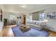 Staged living room with hardwood floors, neutral decor, and plenty of natural light at 3600 Olive St, Denver, CO 80207