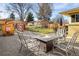 Backyard with a fire pit, seating area, a playhouse and storage shed at 169 Emerald St, Broomfield, CO 80020