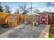 Backyard featuring a playhouse, chicken coop, and storage shed, perfect for outdoor activities at 169 Emerald St, Broomfield, CO 80020