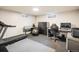 A finished basement featuring workout equipment, office space, and a dedicated area for various activities at 169 Emerald St, Broomfield, CO 80020