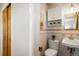 A charming bathroom with a stylish sink, a toilet, neutral tiles, and tasteful decorations at 169 Emerald St, Broomfield, CO 80020