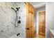A modern bathroom showcasing a luxurious tiled shower with matte black fixtures and a glass partition at 169 Emerald St, Broomfield, CO 80020