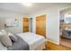 Bedroom with wood floors, closet, bathroom access, and comfortable, inviting bedding and stylish accents at 169 Emerald St, Broomfield, CO 80020
