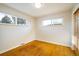 A well-lit bedroom featuring hardwood floors and two windows providing ample natural light at 169 Emerald St, Broomfield, CO 80020