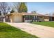 Charming single-story home with a well-manicured lawn and beautiful landscaping at 169 Emerald St, Broomfield, CO 80020