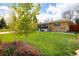 Single-story home with a well-manicured lawn and beautiful landscaping at 169 Emerald St, Broomfield, CO 80020