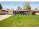 Charming single-story home with a well-manicured lawn and beautiful landscaping at 169 Emerald St, Broomfield, CO 80020