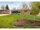 Charming single-story home with a well-maintained lawn and mature landscaping at 169 Emerald St, Broomfield, CO 80020