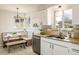 Well-lit kitchen with stainless steel appliances, banquette seating, and charming decor at 169 Emerald St, Broomfield, CO 80020