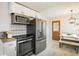 Modern kitchen with stainless steel appliances, white cabinetry, and eat-in nook at 169 Emerald St, Broomfield, CO 80020