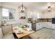 Bright kitchen nook with built-in seating, granite countertops, and ample storage at 169 Emerald St, Broomfield, CO 80020