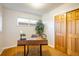 Bright home office features wood floors, natural light, a modern desk, and a closet for storage at 169 Emerald St, Broomfield, CO 80020
