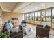 Relaxing sunroom with large windows, cozy seating, and view of the neighborhood at 169 Emerald St, Broomfield, CO 80020