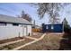 Backyard with detached garage and studio, connected by concrete walkway at 1937 Jay St, Lakewood, CO 80214