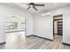 Bright bedroom with wood floors, ceiling fan, and a glimpse into the closet at 1937 Jay St, Lakewood, CO 80214