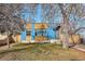 Charming home with a well-maintained front yard, mature trees, and blue painted exterior at 1937 Jay St, Lakewood, CO 80214