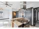 Well-designed kitchen with a gas range, granite counters, and easy flow to adjacent living space at 1937 Jay St, Lakewood, CO 80214