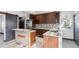 Modern kitchen with stainless steel appliances, granite countertops, and ample cabinet space at 1937 Jay St, Lakewood, CO 80214