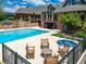 Expansive backyard with a pool, hot tub, seating area, and access to the home's interior at 8000 N 41St St, Longmont, CO 80503