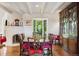 Charming dining area features a decorative fireplace, hardwood floors, and a large bay window with garden views at 8000 N 41St St, Longmont, CO 80503