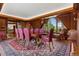 Elegant dining room with wood paneling, large window with a view, and seating for ten at 8000 N 41St St, Longmont, CO 80503