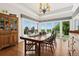 Bright dining room with large windows offering panoramic views, hardwood floors, and stylish decor at 8000 N 41St St, Longmont, CO 80503