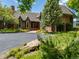 Charming brick home with arched windows and well-manicured landscaping, creating a welcoming curb appeal at 8000 N 41St St, Longmont, CO 80503