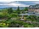 Beautifully landscaped backyard with lush greenery, stone walls, and a glimpse of the house's garage at 8000 N 41St St, Longmont, CO 80503