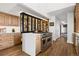 Elegant kitchen featuring a large island, custom cabinets, stainless steel appliances, and hardwood floors at 8000 N 41St St, Longmont, CO 80503