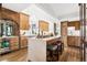 Spacious kitchen with a marble island, bar stool seating, custom cabinets, and hardwood floors at 8000 N 41St St, Longmont, CO 80503