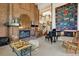 Cozy living room featuring a brick fireplace, high ceilings, piano, and staircase to upper level at 8000 N 41St St, Longmont, CO 80503