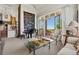 Comfortable living room with grand piano, fireplace, high ceilings, and sliding glass doors to patio at 8000 N 41St St, Longmont, CO 80503