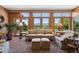 Bright sunroom with stone floors, large windows, and serene views of the surrounding landscape at 8000 N 41St St, Longmont, CO 80503