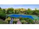 Beautifully landscaped tennis court featuring shaded benches, and manicured flower beds with a scenic backdrop at 8000 N 41St St, Longmont, CO 80503