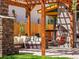 Serene backyard seating area with comfortable furniture, stone fireplace, and inviting hanging chair at 4348 Umatilla St, Denver, CO 80211