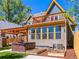 Backyard with a hot tub, garden plots, and a charming two-story house exterior at 4348 Umatilla St, Denver, CO 80211