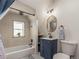 Charming bathroom features a modern vanity, stylish mirror, and tiled shower/tub combo at 4348 Umatilla St, Denver, CO 80211
