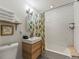 Well-lit bathroom featuring a modern vanity, subway tile shower, and neatly stacked towels at 4348 Umatilla St, Denver, CO 80211