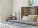 Comfortable bedroom featuring bedside table with lamp and flower decor at 4348 Umatilla St, Denver, CO 80211