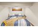Cozy bedroom with neutral decor, a comfortable bed, and a scenic mountain view wall art at 4348 Umatilla St, Denver, CO 80211
