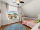 Bright bedroom with a ceiling fan and a large window providing natural light and neighborhood views at 4348 Umatilla St, Denver, CO 80211