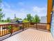 Large deck with wood railings offering views of the surrounding neighborhood at 4348 Umatilla St, Denver, CO 80211