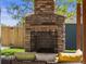Inviting stone fireplace with comfortable seating in an outdoor living space at 4348 Umatilla St, Denver, CO 80211