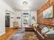 Cozy living room with exposed brick, hardwood floors and plenty of natural light at 4348 Umatilla St, Denver, CO 80211