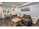 Inviting living room with a comfortable sectional sofa and a table with seating at 4348 Umatilla St, Denver, CO 80211