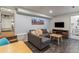 Basement living room with a sectional sofa, television, and access to a bathroom and bedroom at 4348 Umatilla St, Denver, CO 80211